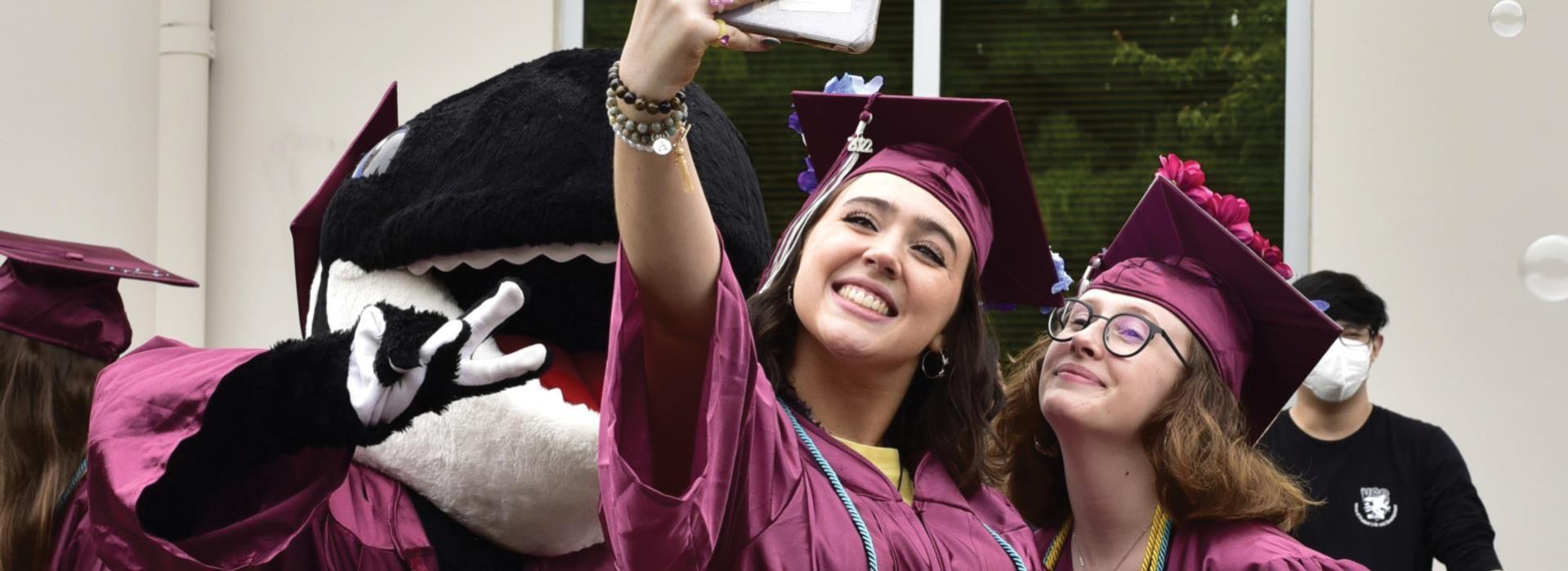 Finny with graduates taking a selfie