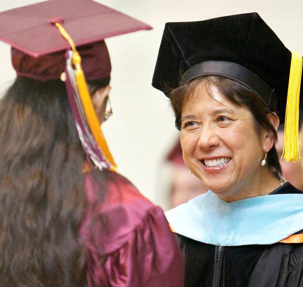 President Kathi congratulating female graduate