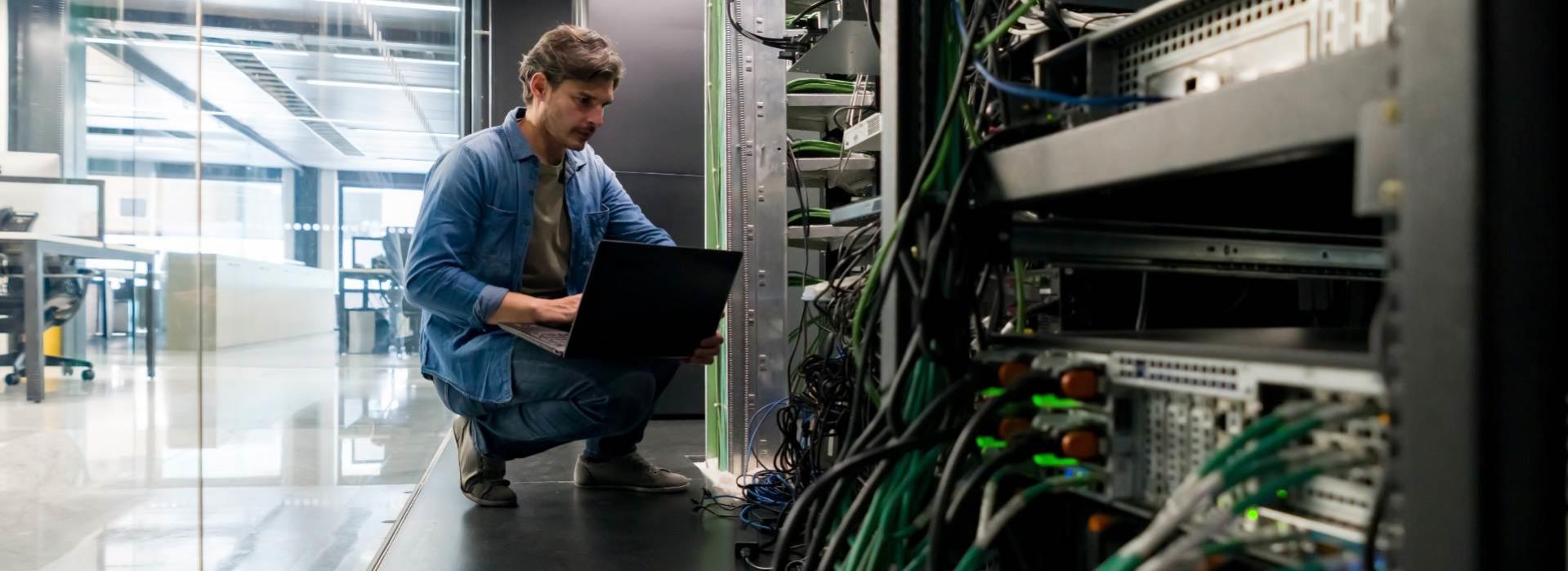 Man troubleshooting system in server room
