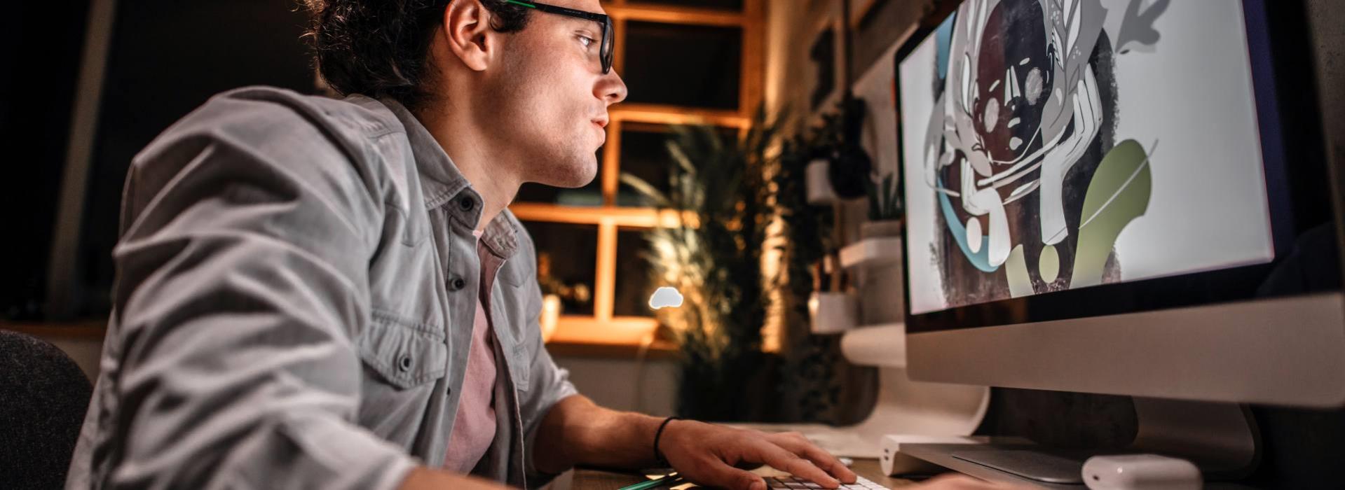 Man working on digital art at night